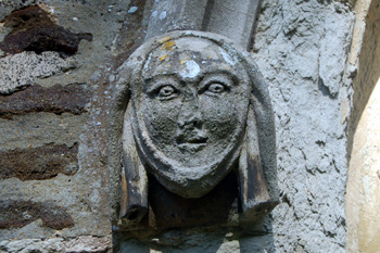 Head on the north side of the west door of Westoning church August 2009